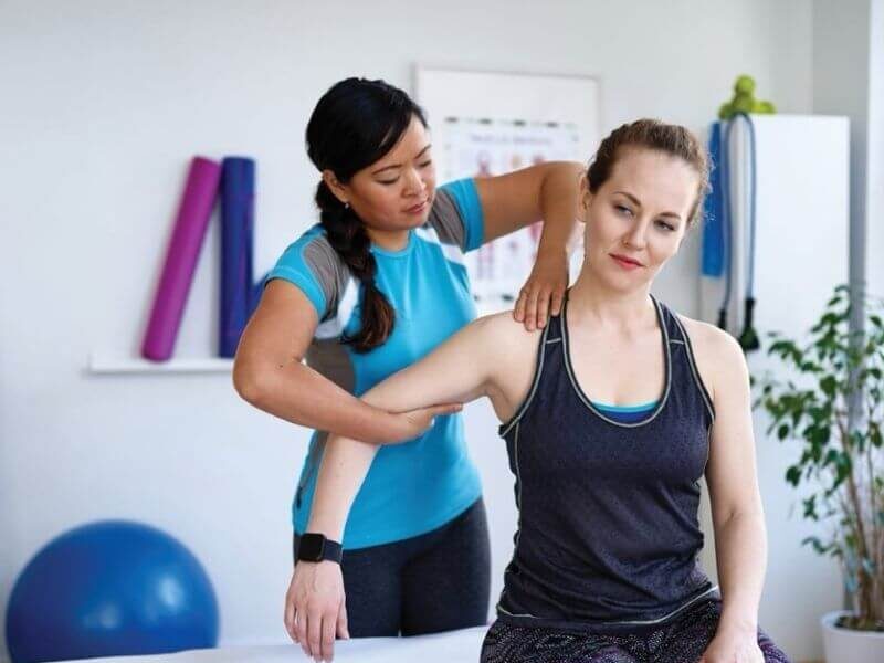 Therapist-massaging-shoulder-of-patient-square-right-align